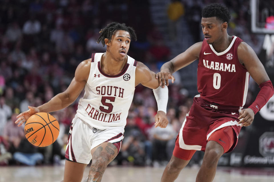 South Carolina guard Meechie Johnson (5) drives against Alabama guard Jaden Bradley (0) during the second half of an NCAA college basketball game Wednesday Feb. 22, 2022, in Columbia, S.C. Alabama won 78-76. (AP Photo/Sean Rayford)