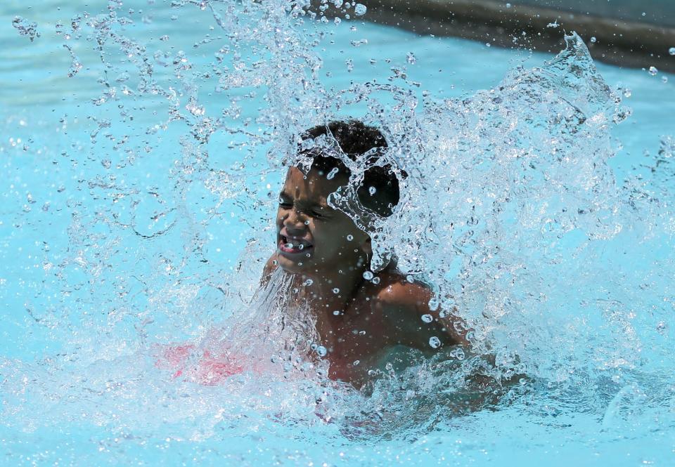 A young boy of the Oklahoma Afterschool Network makes a splash in the water at the Northeast Community Pool in Oklahoma City.