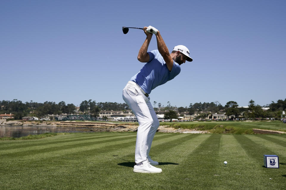 Dustin Johnson hits his tee shot on the 18th hole during a practice round for the U.S. Open Championship golf tournament Tuesday, June 11, 2019, in Pebble Beach, Calif. (AP Photo/David J. Phillip)