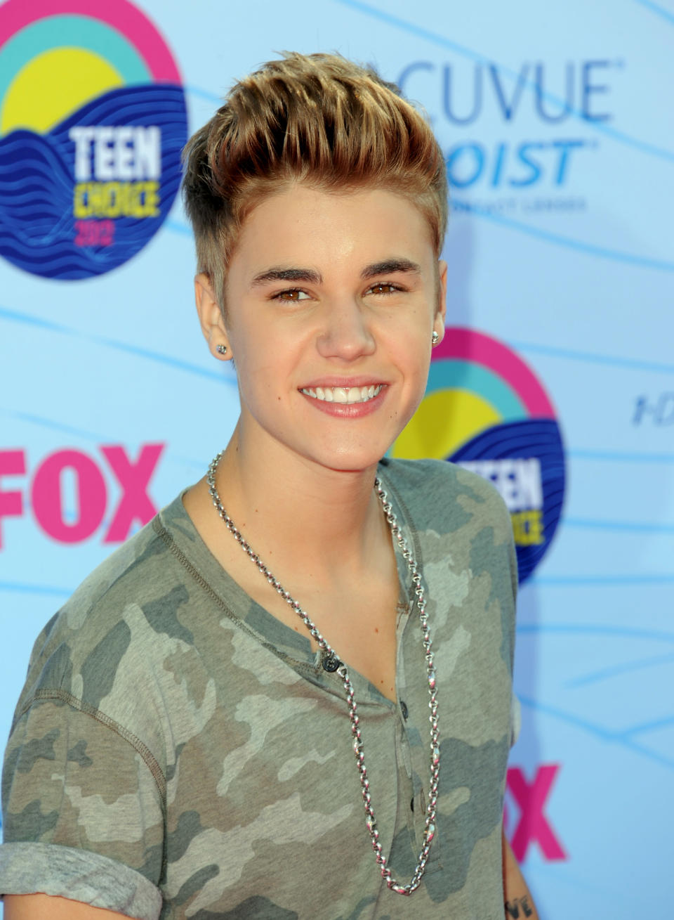 FILE - This July 22, 2012 file photo shows singer Justin Bieber arriving at the Teen Choice Awards in Universal City, Calif. Los Angeles prosecutors have filed criminal charges against a paparazzo photographer for allegedly racing across a Los Angeles freeway in an effort to get photographs of Justin Bieber. The case marks the first use of a 2010 state law designed to prevent paparazzi from dangerously pursuing celebrities for photos. The City Attorney's office said Wednesday that 30-year-old Paul Raef faces four charges, including reckless driving with the intent to capture pictures for commercial gain, following another vehicle too closely, and reckless driving. (Photo by Jordan Strauss/Invision/AP, file)