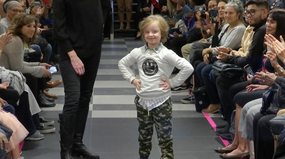 This image from video taken on Wednesday, Oct. 16, 2019 shows a boy participating in the 2nd annual “Gigi’s Playhouse Fashion Show” in New York. Gigi’s Playhouse is an education and achievement center that prepares young people with Down syndrome to engage more fully in their homes, schools and communities. (AP Photo/Gary Gerard Hamilton)