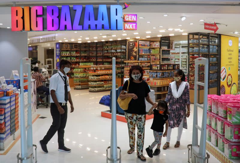 FILE PHOTO: People exit the Big Bazaar retail store in Mumbai