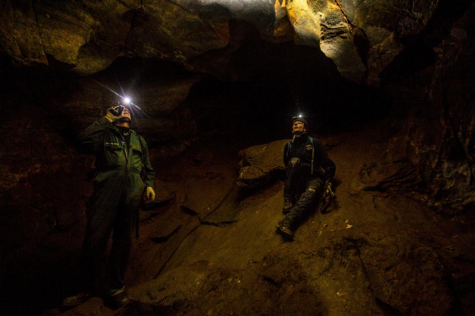 Dave Bobbitt (left), a geologist with the U.S. Forest Service, and FWP non-game wildlife biologist Lauri Hanauska-Brown, search the walls of Lick Creek Cave in the Little Belt Mountains southeast of Great Falls for bats they can test for white-nose syndrome. The syndrome has killed millions of bats in the eastern United States and Canada, and was recently detected in Lick Creek Cave.