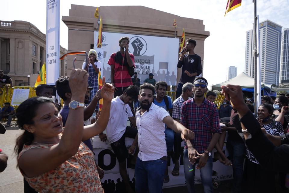 Protesters dance shouting slogans against president Gotabaya Rajapaksa outside his office in Colombo, Sri Lanka, Wednesday, July 13, 2022. The president of Sri Lanka fled the country early Wednesday, slipping away in the middle of the night only hours before he was to step down amid a devastating economic crisis that has triggered severe shortages of food and fuel. (AP Photo/Eranga Jayawardena)