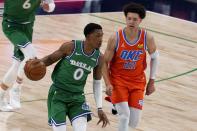 Dallas Mavericks guard Josh Richardson (0) advances the ball up court under pressure from Oklahoma City Thunder center Isaiah Roby (22) in the first half of an NBA basketball game in Dallas, Wednesday, March 3, 2021. (AP Photo/Tony Gutierrez)