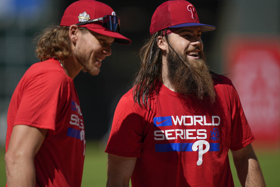 Philadelphia Phillies third baseman Alec Bohm, left, and Philadelphia Phillies center fielder Brandon Marsh speak ahead of Game 1 of the baseball World Series between the Houston Astros and the Philadelphia Phillies on Thursday, Oct. 27, 2022, in Houston. Game 1 of the series starts Friday. (AP Photo/Eric Gay)