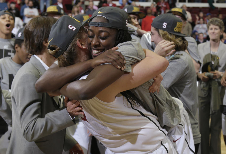 Stanford forward Chiney Ogwumike, front right, hugs forward Mikaela Ruef after Stanford defeated North Carolina 74-65 in a regional final of the NCAA women's college basketball tournament in Stanford, Calif., Tuesday, April 1, 2014. (AP Photo/Marcio Jose Sanchez)
