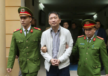 PVC's former chairman Trinh Xuan Thanh (C) is escorted by policemen from a court to prison after a verdict session in Hanoi, Vietnam January 22, 2018. VNA/Doan Tan via REUTERS