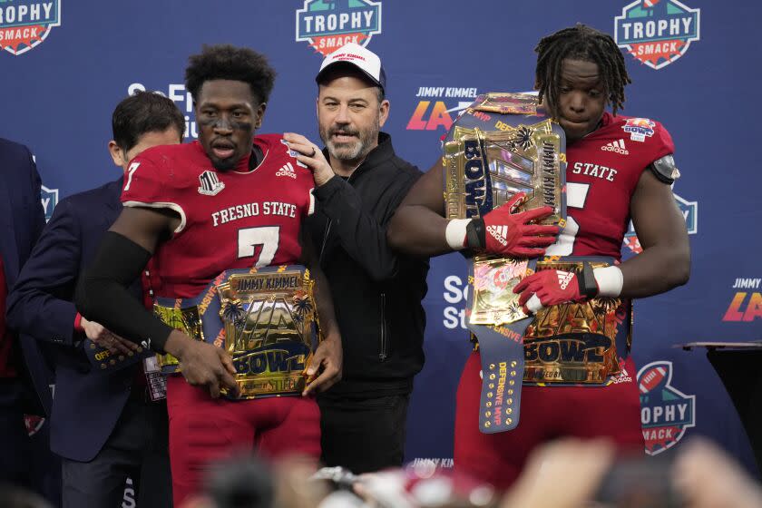 Jimmy Kimmel greets Fresno State running back Jordan Mims (7) and defensive lineman.