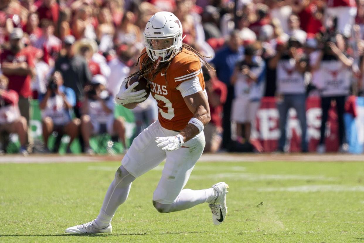 Texas wide receiver Jordan Whittington (13) turns upfield against Oklahoma.