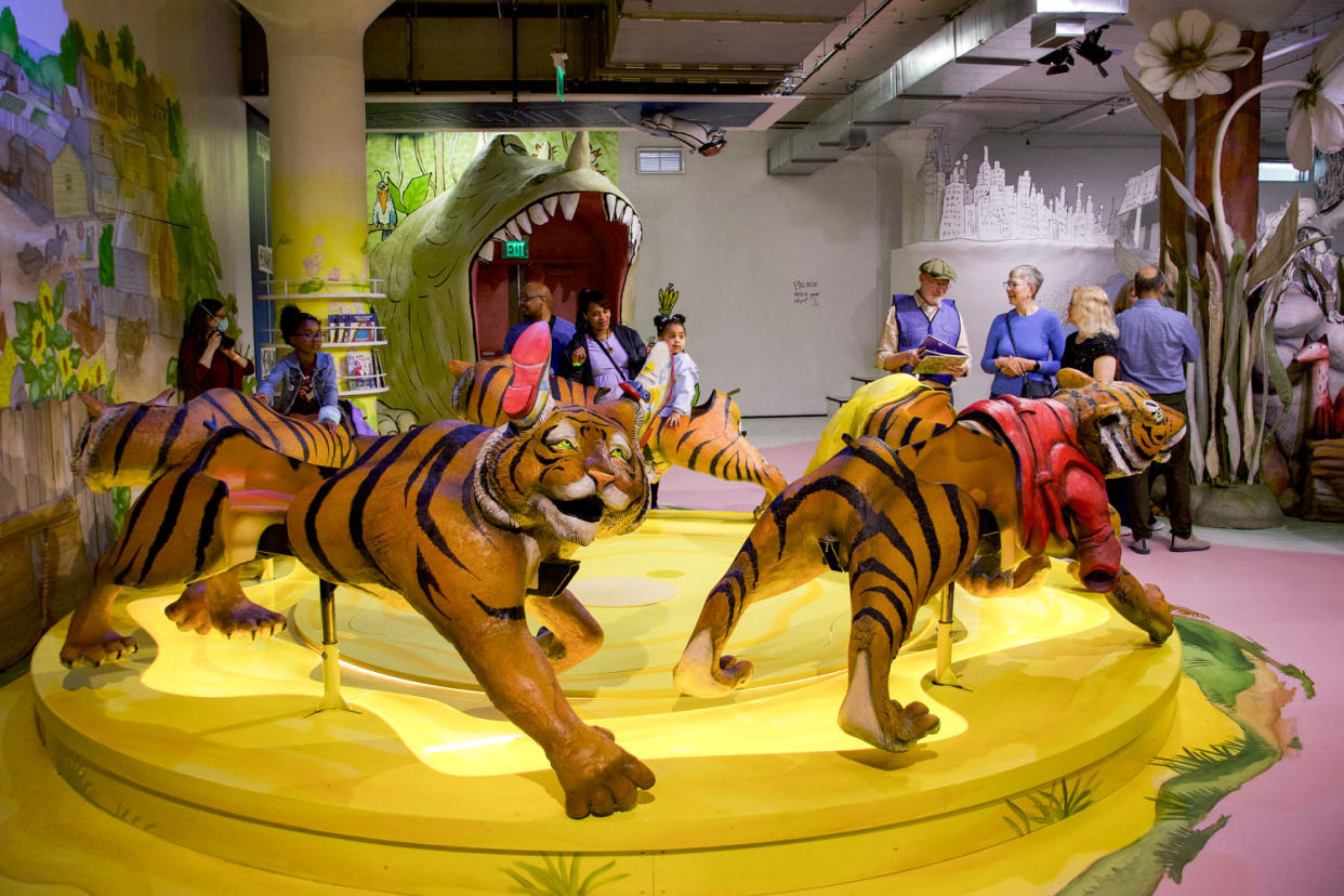 Children play on a carousel with tiger characters as the seats (Courtesy The Rabbit hOle)