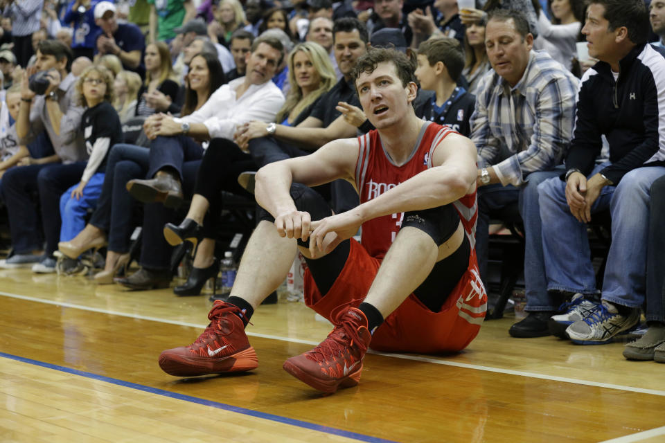 Houston Rockets center Omer Asik sits on the court after being charged with a foul during the fourth quarter of an NBA basketball game against the Minnesota Timberwolves in Minneapolis, Friday, April 11, 2014. The Timberwolves won 112-110. (AP Photo/Ann Heisenfelt)