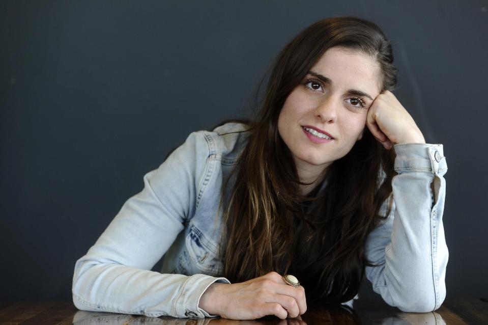 In this photo taken Friday, May 2, 2014 Rosa da Silva, in the role of Anne, poses during an interview with the Associated Press at Theater Amsterdam. Seeking to engage a new generation with the tragic story of Anne Frank, a major new play based on the Jewish teenager's diary opens Thursday, May 8, 2014 in Amsterdam. It's the first time a theatrical production has been forged directly from Frank's actual writings since the award-winning 1950s play that escalated her story, then little-known, to the world's attention. It's being staged in a purpose-built 1,100 seat theater that includes a replica of the secret apartment where Frank and her family hid from the Nazis in World War II. (AP Photo/Evert Elzinga)