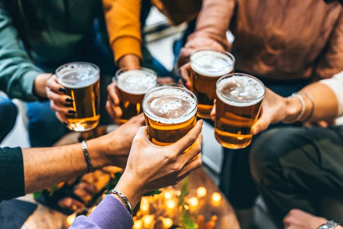 Group of people toasting with beer glasses