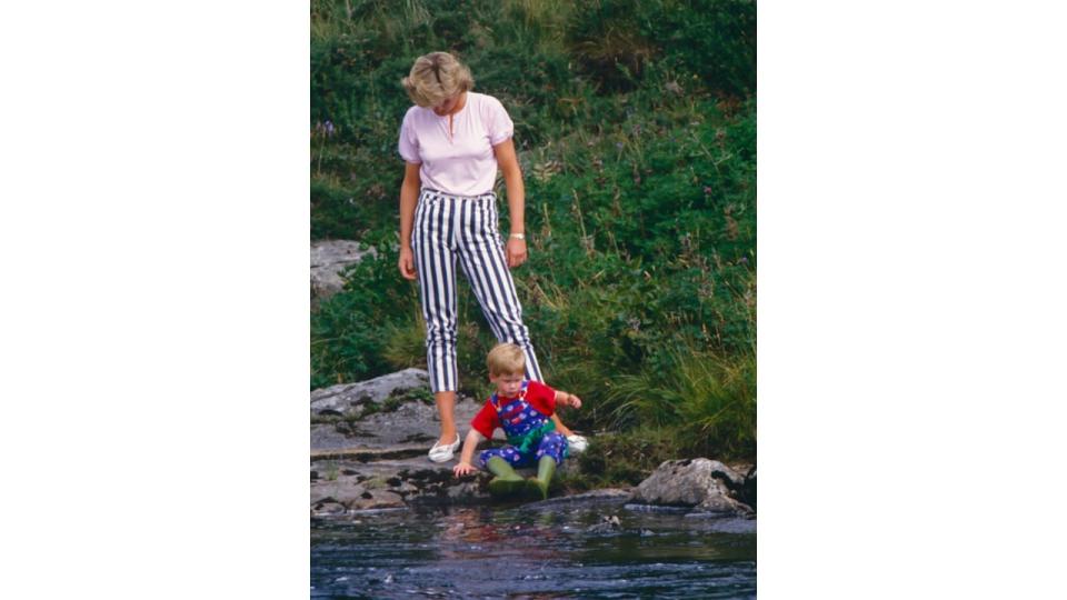 Diana, Princess of Wales, and Prince Harry play on the banks of the River Dee, near Balmoral Castle.