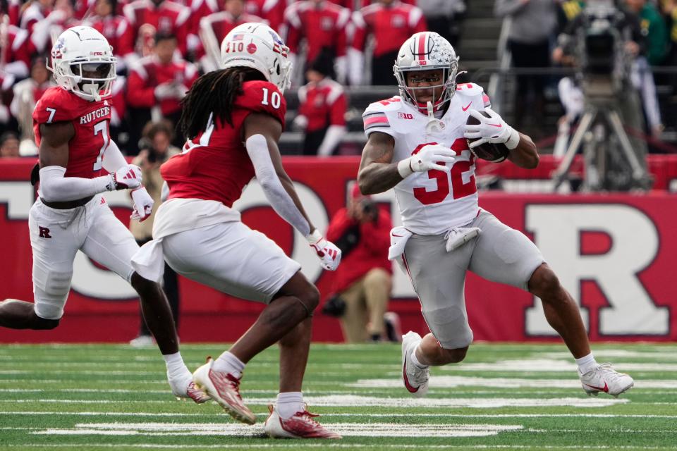 Ohio State's TreVeyon Henderson runs at Rutgers defensive back Flip Dixon on Saturday.