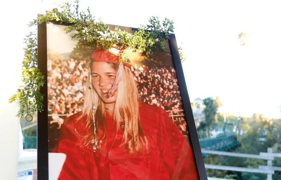 A large portrait of Kristin Smart in graduation attire is on display at a candlelight vigil for the Cal Poly student in Arroyo Grande in 2020.