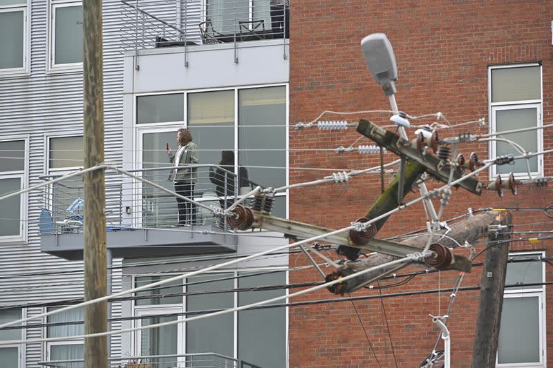 Residents view damage along Woodland Street after a tornado touched down in Nashville