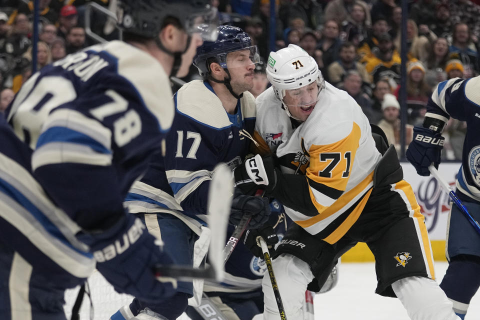 Columbus Blue Jackets right wing Justin Danforth (17) defends against Pittsburgh Penguins center Evgeni Malkin (71) during the first period of an NHL hockey game Tuesday, Nov. 14, 2023, in Columbus, Ohio. (AP Photo/Sue Ogrocki)