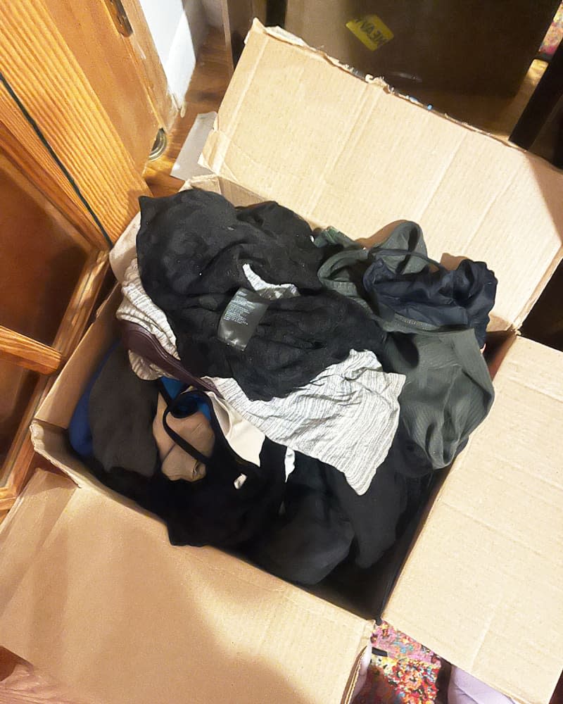 Box of clothes on floor