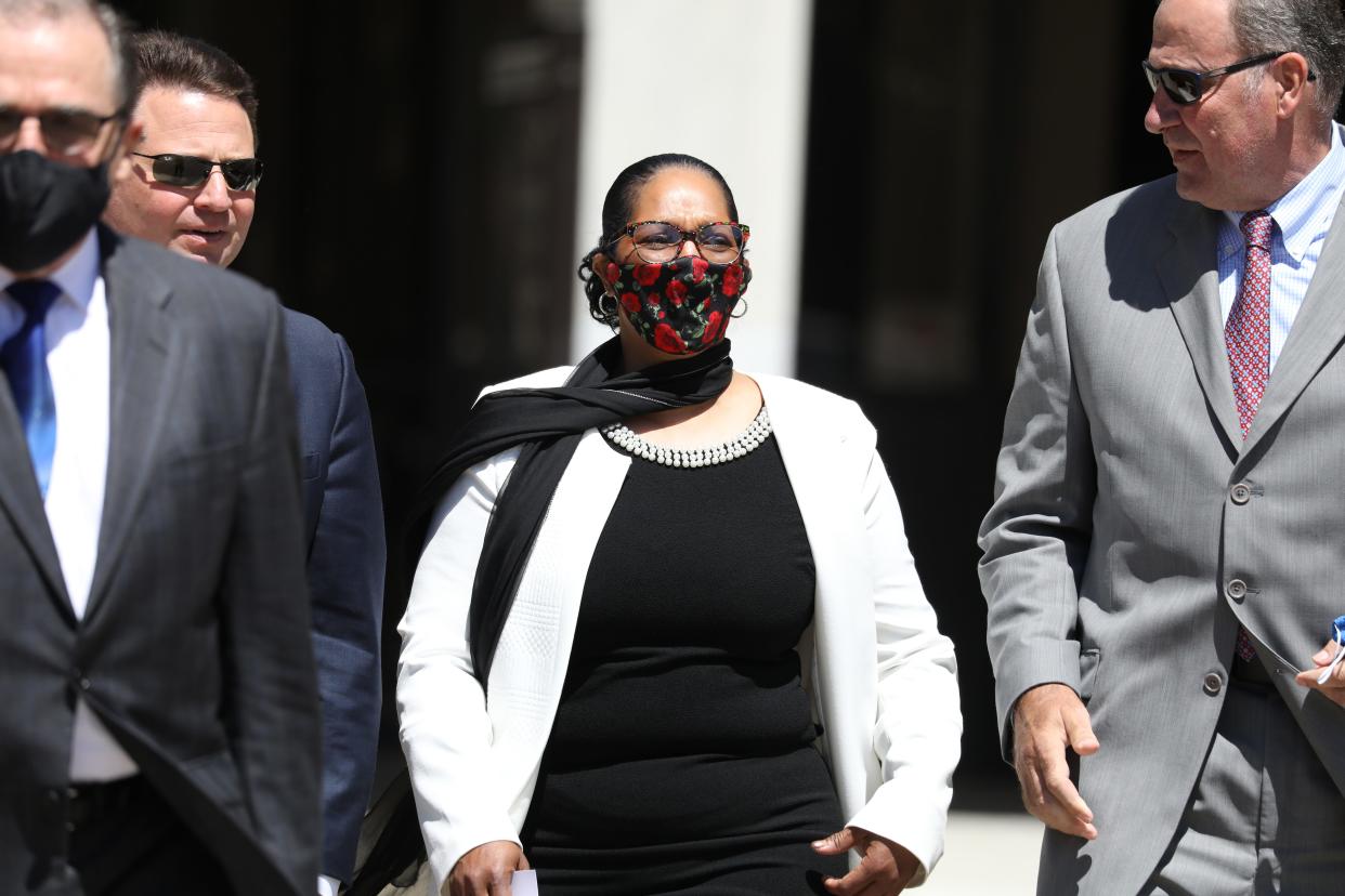 Janis White, center, leaves Federal Court after pleading guilty to wire fraud in June 2021 in downtown Rochester.