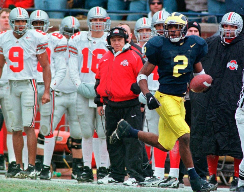 The Ohio State bench watches as Michigan's Charles Woodson returns a punt 78 yards for a touchdown in 1997.