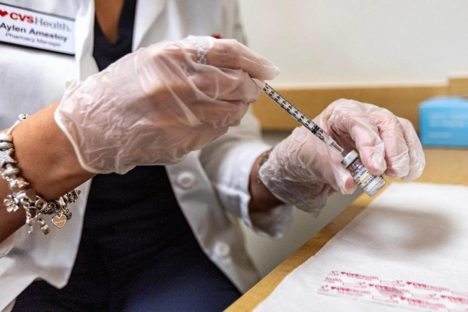 CVS Health Pharmacy Manager Aylen Amestoy prepares to administer the newest COVID-19 vaccine shot at a CVS in Miami, Florida, on Thursday, September 14, 2023.