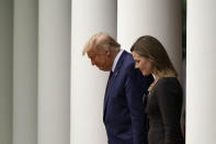 President Donald Trump walks with Judge Amy Coney Barrett to a news conference to announce Barrett as his nominee to the Supreme Court, in the Rose Garden at the White House, Saturday, Sept. 26, 2020, in Washington. (AP Photo/Alex Brandon)