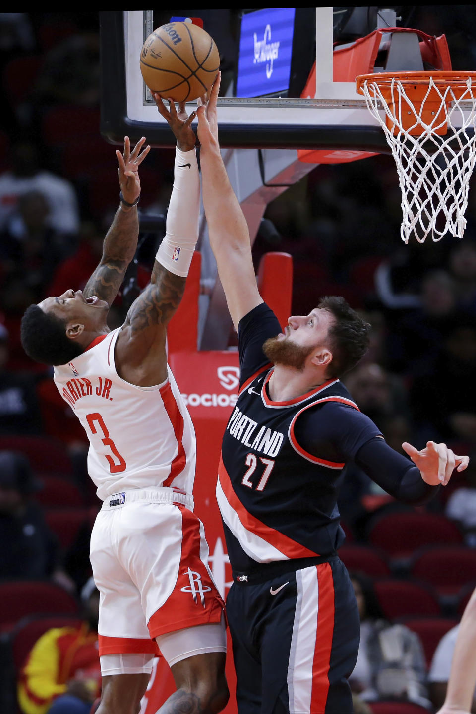 Houston Rockets guard Kevin Porter Jr. (3) has his shot blocked by Portland Trail Blazers center Jusuf Nurkic (27) during the first half of an NBA basketball game Saturday, Dec. 17, 2022, in Houston. (AP Photo/Michael Wyke)