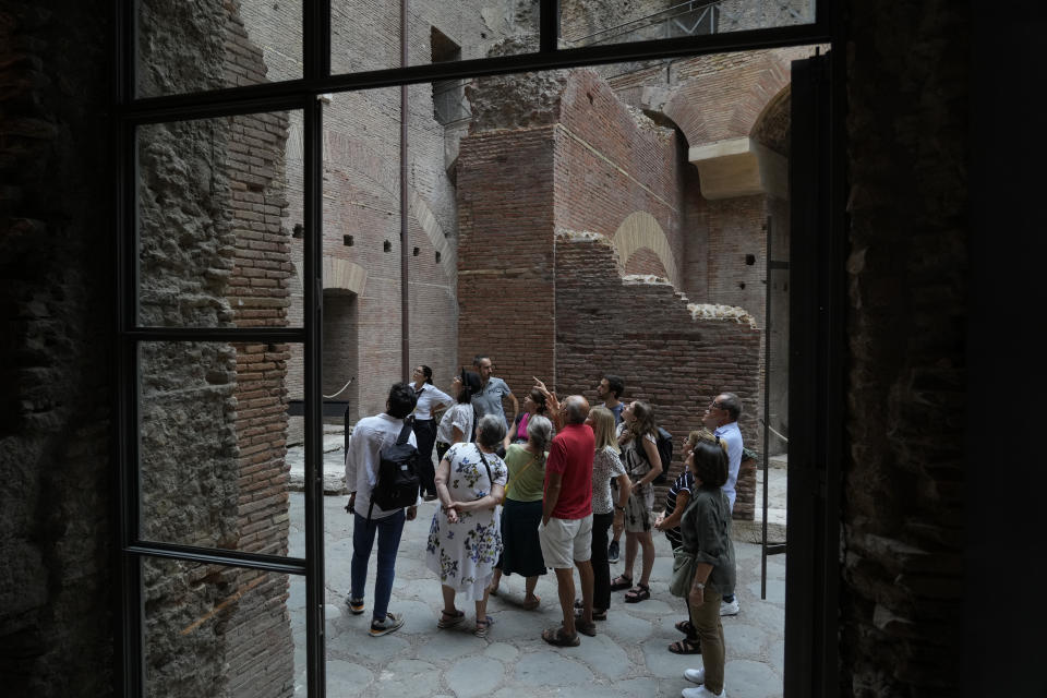 Visitors admire the newly restored domus Tiberiana, one of the main imperial palaces, during the press preview on Rome's Palatine Hill, in Rome, Italy, Wednesday, Sept. 20, 2023. The Domus Tiberiana will reopen to the public on Sept. 21. (AP Photo/Gregorio Borgia)