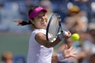 Li Na, of China, hits to Dominika Cibulkova, of Slovakia, during a quarterfinal match at the BNP Paribas Open tennis tournament, Thursday, March 13, 2014 in Indian Wells, Calif. (AP Photo/Mark J. Terrill)