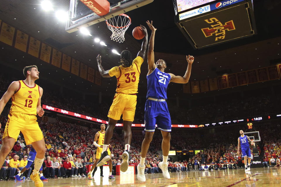 Iowa State forward Solomon Young, center, pulls down a rebound in front of Seton Hall center Ike Obiagu, right, during the first half of an NCAA college basketball game, Sunday, Dec. 8, 2019, in Ames, Iowa. (AP Photo/Matthew Putney)