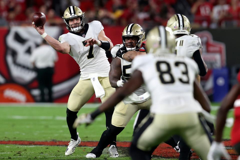 New Orleans Saints quarterback Taysom Hill (7) throws a pass to tight end Juwan Johnson (83) against the Tampa Bay Buccaneers during the second half of an NFL football game Sunday, Dec. 19, 2021, in Tampa, Fla. (AP Photo/Mark LoMoglio)