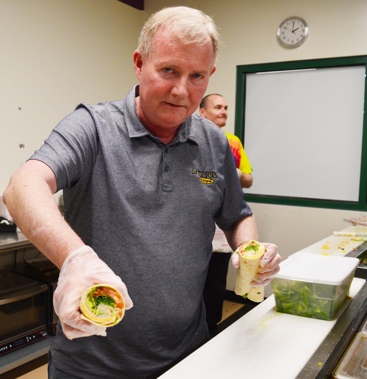 Tom Seybert shows what's in one of the popular cold sandwiches at the Roly Poly Sandwich shop at the Ivy Tech Bloomington campus on Feb. 22, 2024.