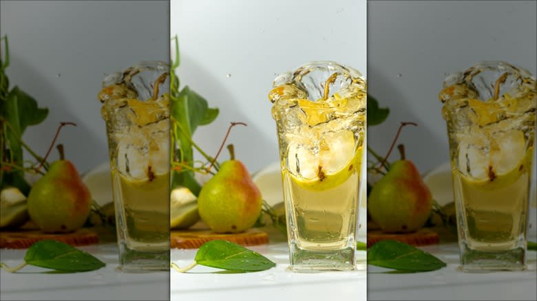 Pear cider splashing out of glass