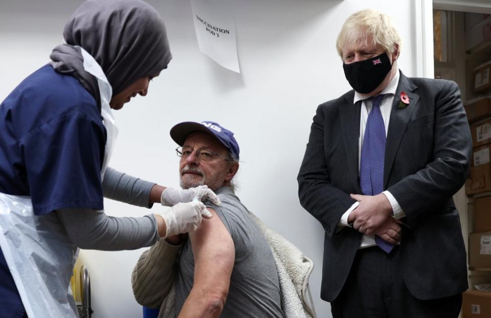 Prime Minister Boris Johnson watches a man receiving a coronavirus vaccination in a pharmacy in Sidcup, Kent (Henry Nicholls/PA) (PA Wire)