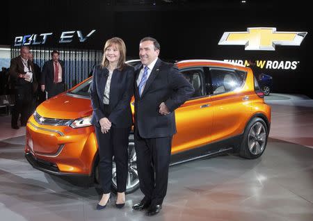 General Motors CEO Mary Barra and Alan Batey, President of GM North America, pose next to the Chevrolet Bolt EV electric concept car after it was unveiled during the first press preview day of the North American International Auto Show in Detroit, Michigan January 12, 2015. REUTERS/Rebecca Cook