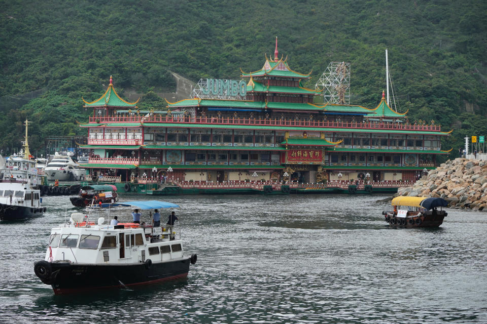 Hong Kong's iconic Jumbo Floating Restaurant is towed away in Hong Kong, Tuesday, June 14, 2022. Hong Kong's iconic restaurant on Tuesday departed the city, after its parent company failed to find a new owner and lacked funds to maintain the establishment amid months of COVID-19 restrictions. (AP Photo/Kin Cheung)