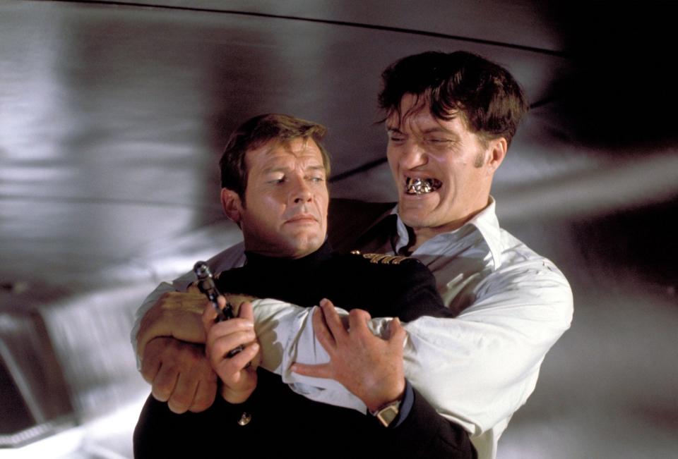 Richard Kiel holding onto Roger Moore