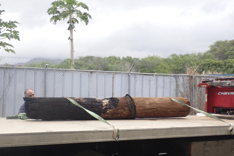 This photo provided by the Morgan & Morgan law firm shows a removed power pole stump on a truck outside an evidence warehouse in Maui, Hawaii on Aug. 29, 2023. Investigators are examining pieces of evidence as they seek to solve the mystery of how a small, wind-whipped fire sparked by downed power lines and declared extinguished flare up again hours later into a devastating inferno. (Morgan & Morgan via AP)