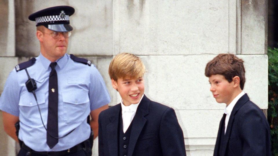 Prince William and a teenager walking past a security guard