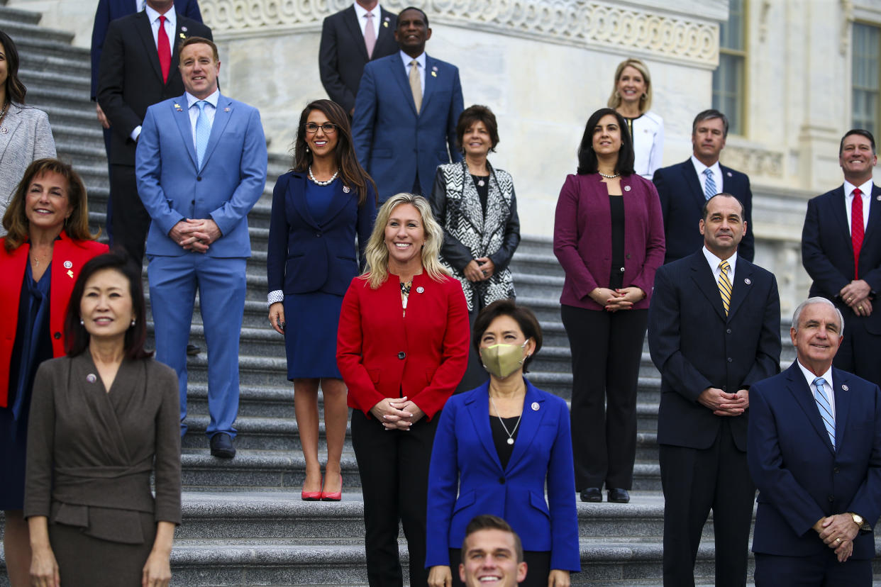 Rep. Marjorie Taylor Greene (R-GA) (Center, in red) and other newly elected Republican House members meet on the East Front of the US Capitol for a group photo. (Photo by Tasos Katopodis/Getty Images)