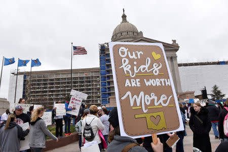 Teachers rally outside the state Capitol for the second day of a teacher walkout to demand higher pay and more funding for education in Oklahoma City, Oklahoma, U.S., April 3, 2018. REUTERS/Nick Oxford