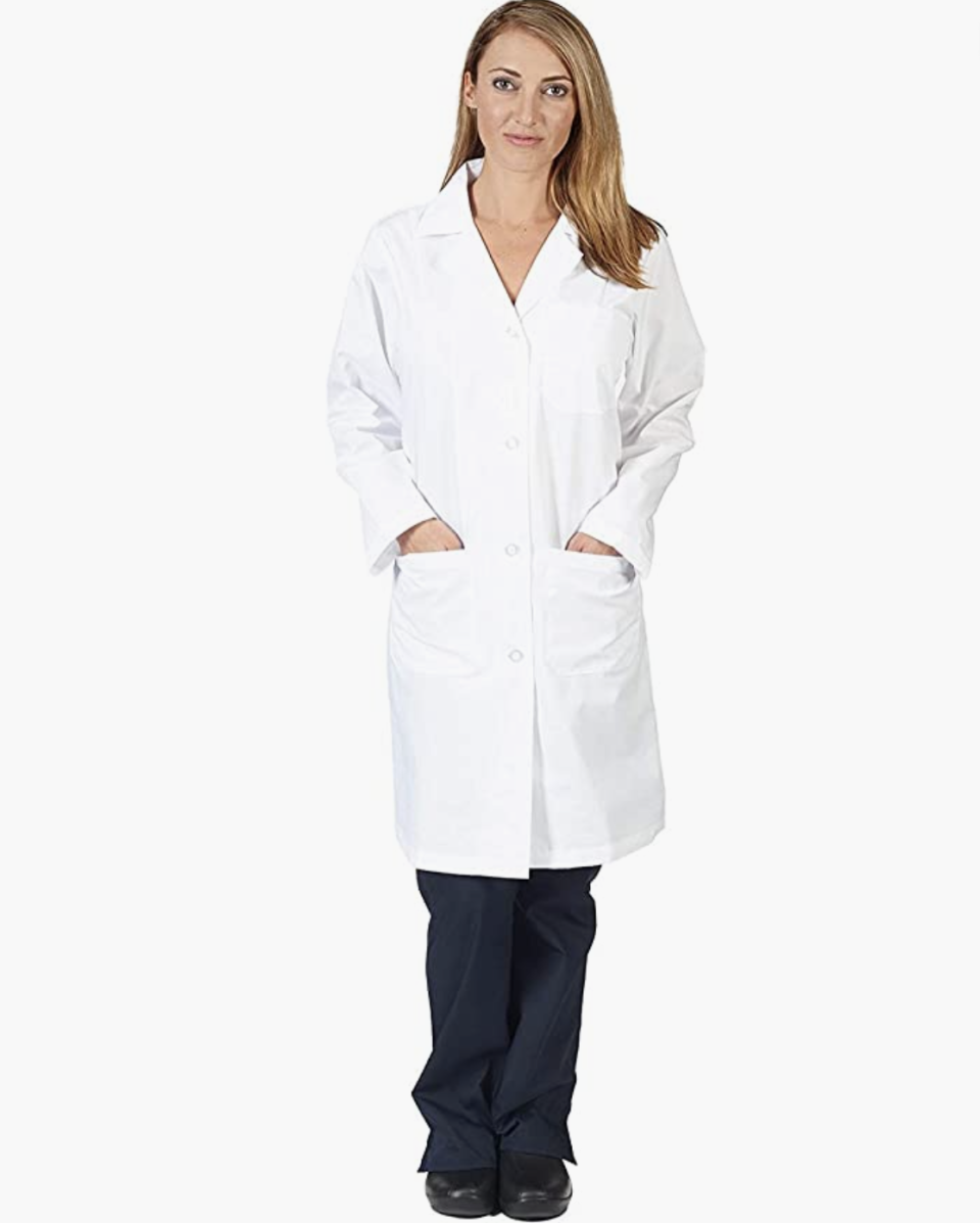 model wears  Natural Uniforms Unisex 40 inch Lab Coat Long Sleeve Professional Medical Coat in white