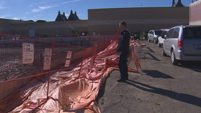 Theatre company parking lot sinks into construction site next door