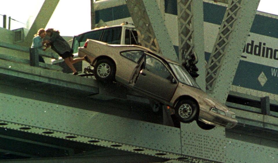 A stunt double for Kim Basinger takes a fleeing posture as a car starts to fall from the Blue Water Bridge in September 1999. The car, which exploded after it started falling, is in a scene where Kim Basinger heads the wrong way up a crowded one-way bridge only to crash over the edge to a river below. The double maintained the pose for a few seconds until the car slid off of its railing into the river.