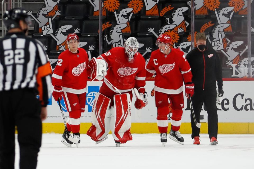 Red Wings center Vladislav Namestnikov, left, and center Dylan Larkin help goaltender Jonathan Bernier off the ice after an injury during the second period of the 3-2 win over the Stars on Thursday, March 18, 2012, at Little Caesars Arena.