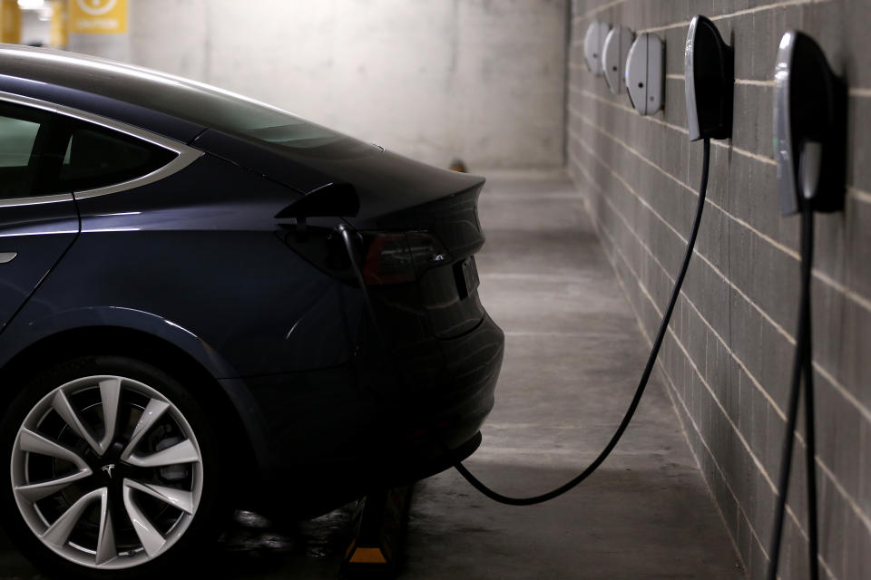 Tesla Model Y charges at a EV charge station