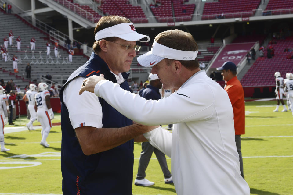 Auburn coach Gus Malzahn talks with Arkansas coach Chad Morris before an NCAA college football game, Saturday, Oct. 19, 2019 in Fayetteville, Ark. (AP Photo/Michael Woods)