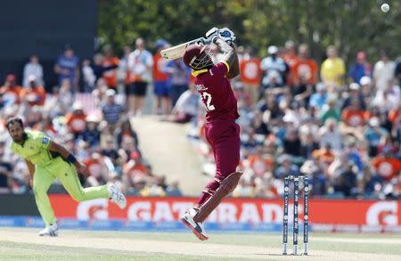 West Indies batsman Andre Russell follows a loose delivery from Pakistan's Wahab Riaz (L) during their Cricket World Cup match in Christchurch, February 21, 2015. REUTERS/Nigel Marple